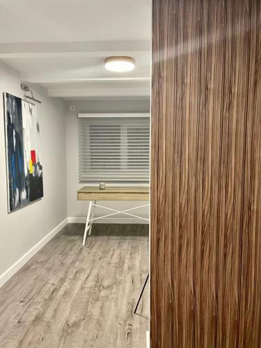 a room with a wooden door with a table in it at Express Inn in Poti