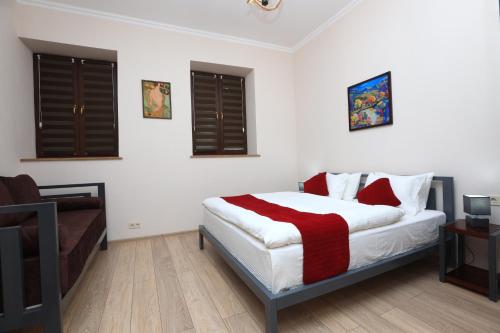 a bedroom with a bed and a couch at Syune Mini Hotel in Gyumri