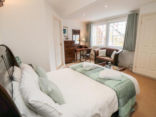 a bedroom with a large white bed in a room at Fawcet House in Whitby