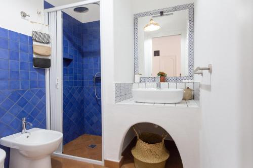 a bathroom with a tub and a sink and a mirror at ALESSANDRAB&B in Lipari