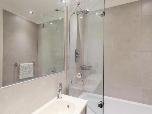 a bathroom with a sink and a glass shower at Fairview in Bowness-on-Windermere