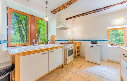a kitchen with white cabinets and a sink at Gorgeous Home In Caylus in Caylus