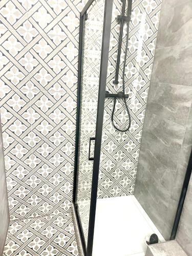 a shower with a glass door in a bathroom at Small One bedroom flat near Covent garden in London