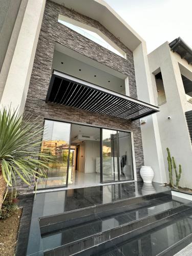 a contemporary house with a glass facade at Oikos 9 Rooms and Suites in Nafpaktos