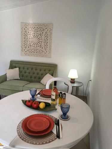 a white table with a plate of food on it at Aphrodite's hidden gem on Paxos island in Velianitátika