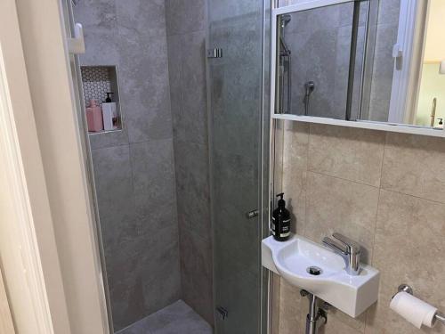 a bathroom with a shower and a sink at Private 1 bedroom apartment near beach and shops in Sydney