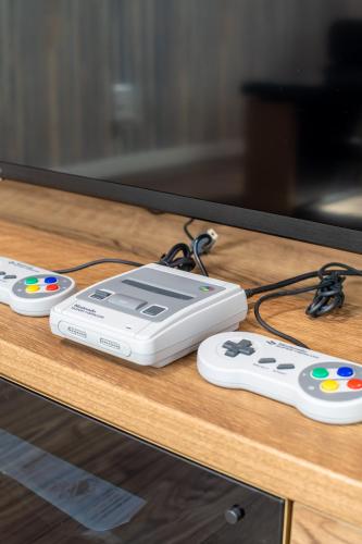 two video game controllers sitting on a table next to a tv at Ici Japon Village in Tokyo