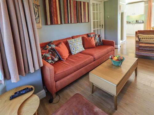 a living room with a red couch and a table at Timley Knott in Coniston