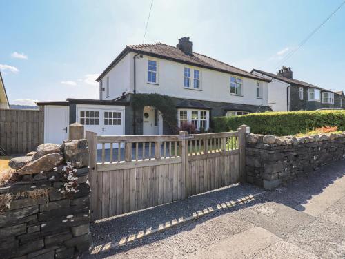 a house with a wooden fence in front of it at Timley Knott in Coniston