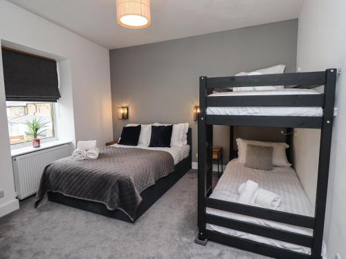 a bedroom with two bunk beds at Muscle Shoals in Seahouses