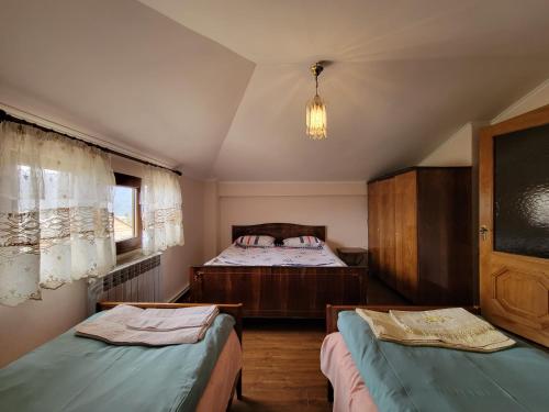 a bedroom with two twin beds and a chandelier at B&B Odzun in Odzun