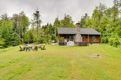 a log cabin with a fireplace in a yard at Secluded Elka Park Cabin Hot Tub and Fire Pit! in Elka Park