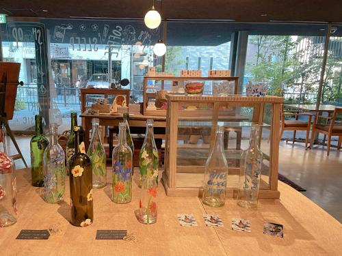 a table with a bunch of wine bottles on it at kamakura seizan in Kamakura