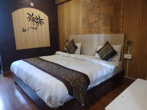 a bedroom with a large white bed in a room at Hotel Great Nainital in Nainital