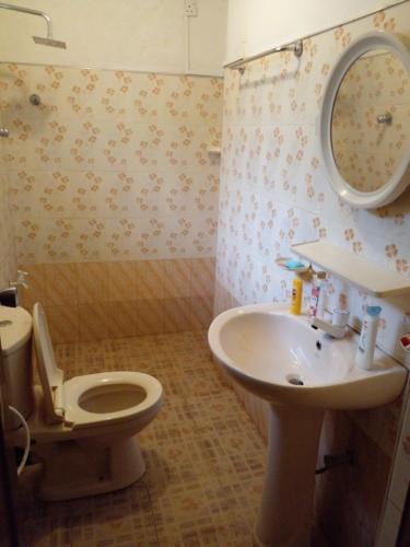 a bathroom with a toilet and a sink at Muthu Villa Sri Lanka in Kalutara