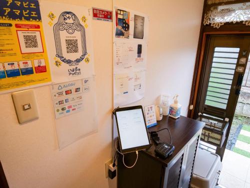 a room with a desk with a tablet on a wall at Family Villa KASAMA - Vacation STAY 42429v in Kasama