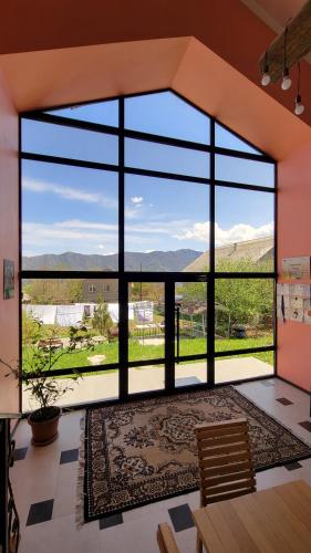 a room with a large window with a view of the mountains at B&B Odzun in Odzun