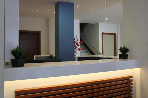 a lobby with a reception desk and a staircase at Filmar Hotel, Ixia, Rhodes in Ixia