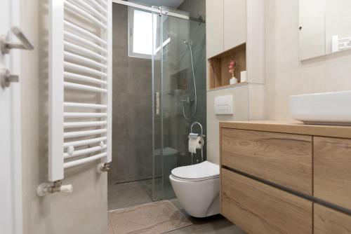 a bathroom with a toilet and a glass shower at Apartment Palazzo, Zagreb town centre in Zagreb