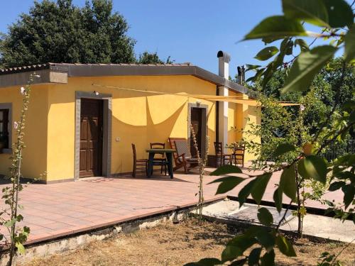 Cette petite maison jaune dispose d'une terrasse. dans l'établissement Timeless Holiday Home in Apecchio with Garden, à Apecchio
