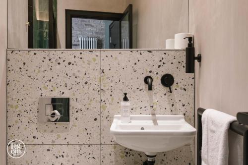 a bathroom with a sink and a mirror at StayLagom in Ballycastle