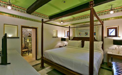 a bedroom with a large bed in a room at Gogunda Palace in Udaipur