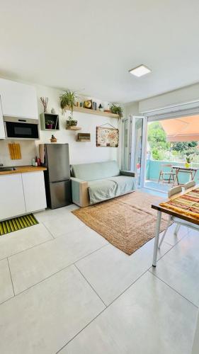 a living room with a table and a kitchen at Silvy's Sunny House in Platamona