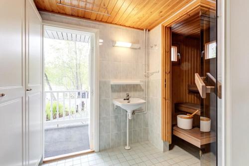 a bathroom with a sink and a window at Villa Kesätie - Lakeside Paradise in Nurmijärvi