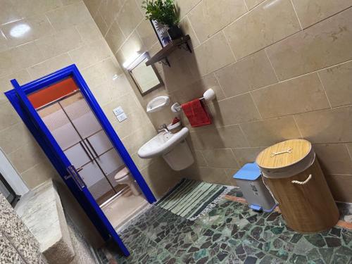 a bathroom with a toilet and a sink at Medusa Home Stay in Amman