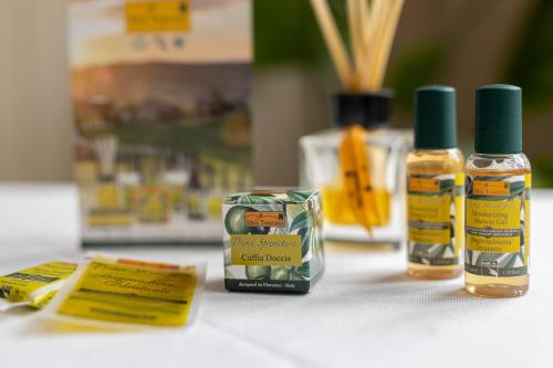 a table with two bottles of oil and a box at Hotel Quisisana in Vada