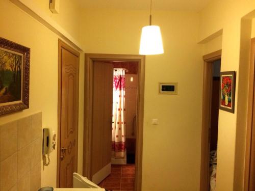 a hallway leading to a bathroom with a light at Apartment Vasco in Paralia Katerinis
