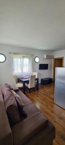 a living room with a couch and a table at Apartments Mery in Supetar