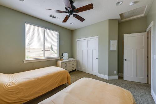 a bedroom with two beds and a ceiling fan at California Vacation Rental with Private Pool and Patio in Visalia