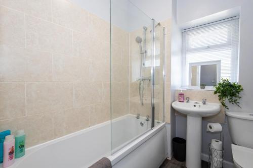 a bathroom with a tub and a sink and a shower at Free Parking Leisure Contractor Central in Rishton