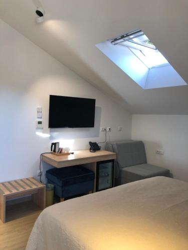 a bedroom with a desk with a tv and a chair at Šangulin Palace V in Biograd na Moru