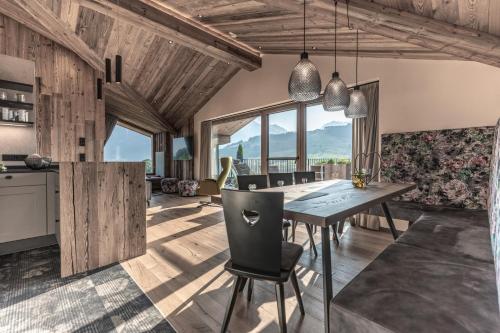 a kitchen and dining room with a table and chairs at Biohof Ebengut in Maria Alm am Steinernen Meer