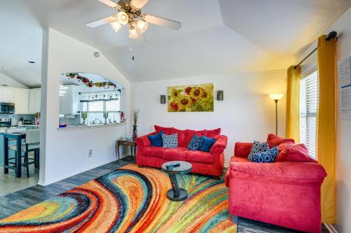 a living room with two red couches and a rug at 4 Mi to ATandT Stadium Home with BBQ in Grand Prairie in Grand Prairie