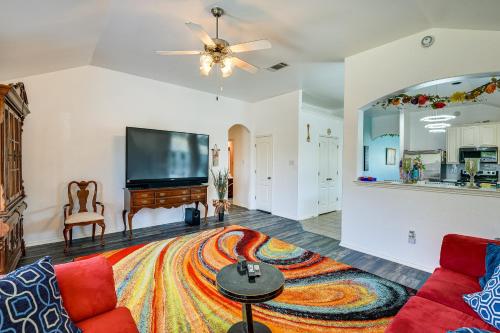 a living room with a couch and a flat screen tv at 4 Mi to ATandT Stadium Home with BBQ in Grand Prairie in Grand Prairie