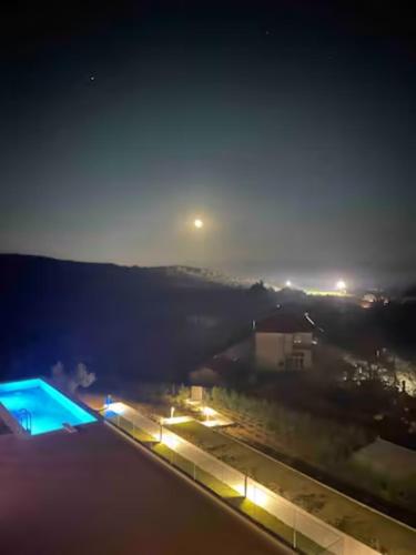 a view of a city at night with lights at #SKGH Arbitrage Hyperluxe Villa -near Pozar Baths & Kaimaktsalan mountain in Sarakinoí