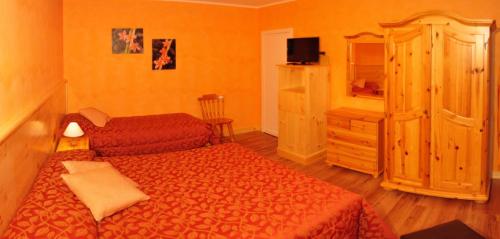 a bedroom with two beds and a dresser at Hotel Miramonti in Gambarie dʼAspromonte