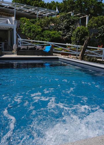 a swimming pool with blue water in a house at Relais Villa Anna in Anacapri