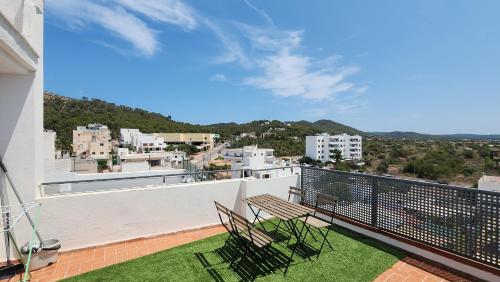 a balcony with chairs and a view of a city at Le Mirage Ibiza in San Antonio