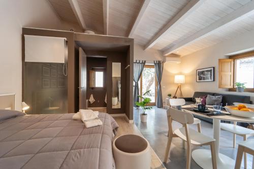 a bedroom with a bed and a dining room at Le vie del Borgo in Civita