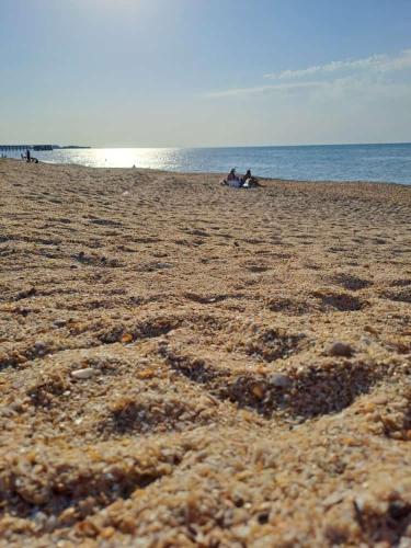 a group of people sitting on a beach at Sea View House in Sumqayyt