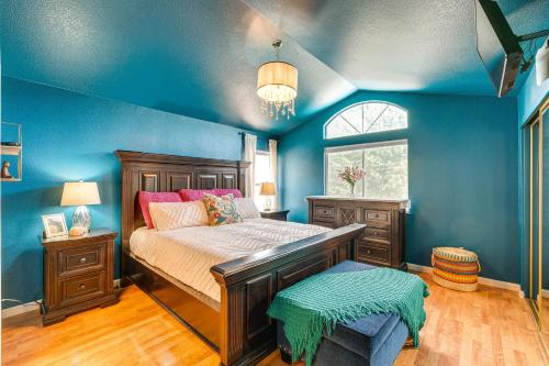 a bedroom with a bed with blue walls and a window at Sacramento Home with Fire Pit 15 Mi to Downtown! in Sacramento