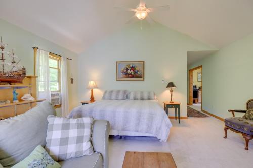 a bedroom with a bed and a couch at Lockes Glen - Lakefront Geneva Getaway with Dock! in Geneva