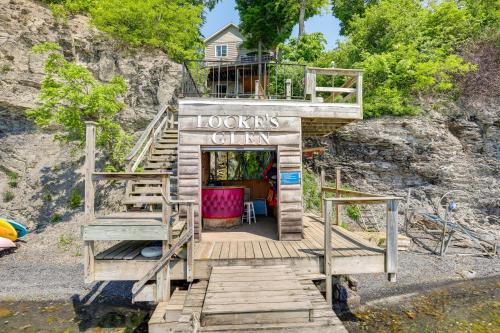a tiny house on a cliff with a building at Lockes Glen - Lakefront Geneva Getaway with Dock! in Geneva