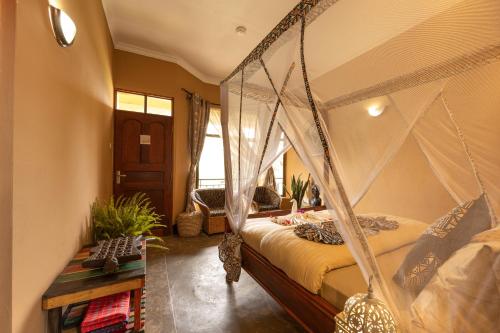 a bedroom with a bed with a canopy at Africa Safari Arusha in Arusha