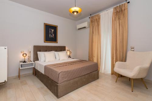 a bedroom with a bed and a chair in it at Villa Moonstone in Mouzákion