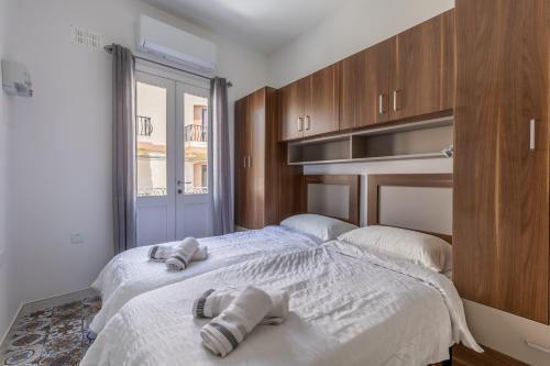 a bedroom with two beds with towels on them at Town House Luqa in Luqa